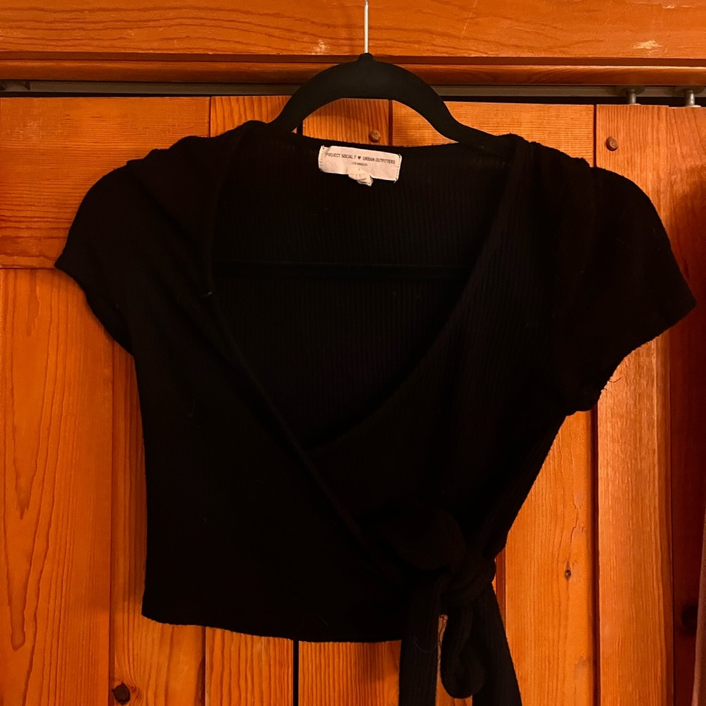 Cap sleeve crop top with wrap tie on side.